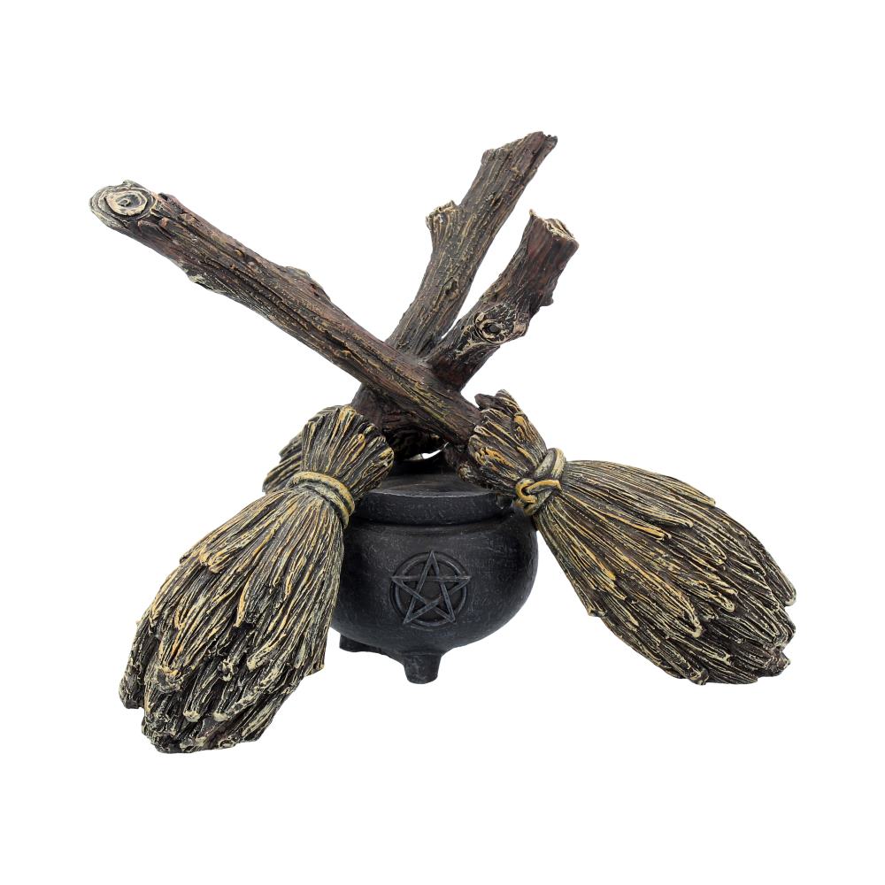 A decorative piece featuring a broomstick and cauldron with a crystal ball holder, designed with a whimsical and mystical appearance.