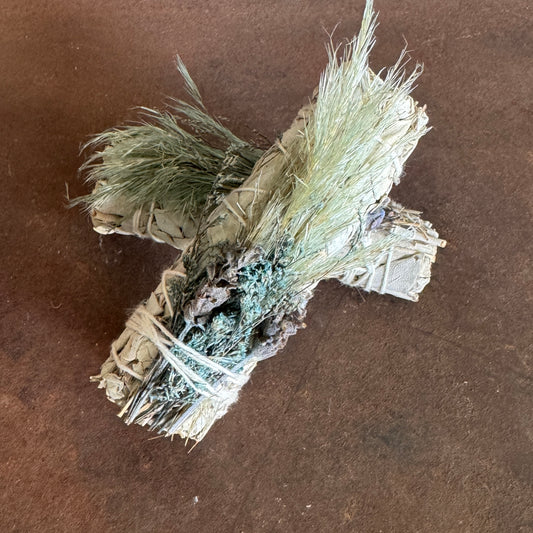 Bundled dried herbs on a brown surface