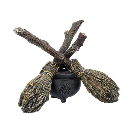 A decorative piece featuring a broomstick and cauldron with a crystal ball holder, designed with a whimsical and mystical appearance.
