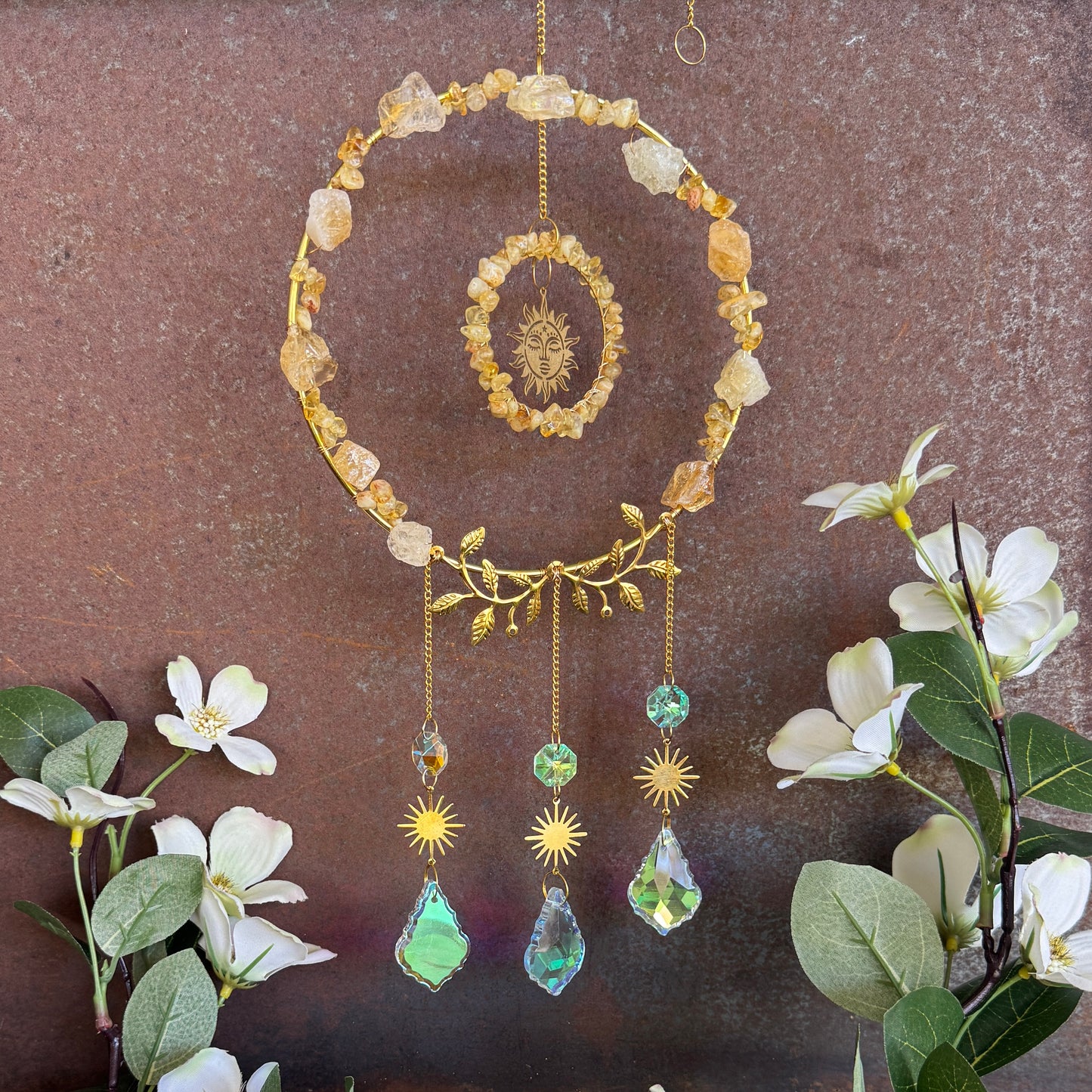 Decorative Citrine crystal  hanging mobile with flowers on a brown background